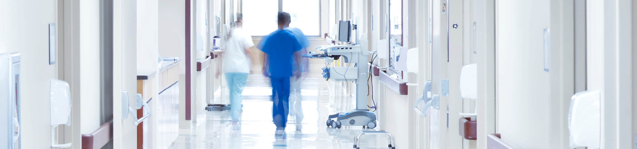 Doctor walking down hospital corridor.