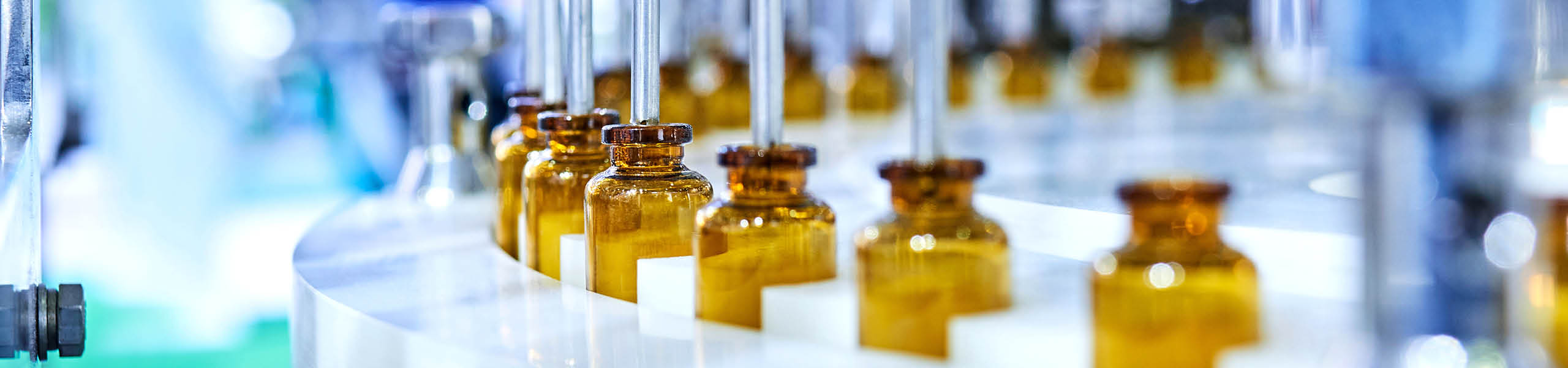 Brown medicine glass bottles on production line.