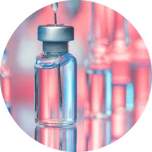 Close up shot of vaccines - glass bottles, ampules and syringe with needle. Good for illustration of flu shot, vaccination and covid-19