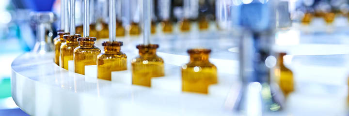 Brown medicine glass bottles on production line.