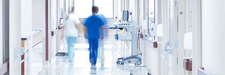 Doctor walking down hospital corridor.