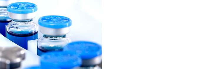 Glass bottles in production in the tray of an automatic liquid dispenser, a line for filling medicines against bacteria and viruses, antibiotics and vaccines